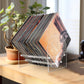 Acrylic vinyl record display stand with stacked records and clear angled shelves