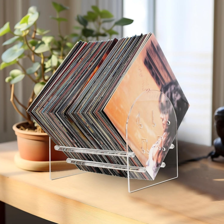 Acrylic vinyl record display stand with stacked records and clear angled shelves