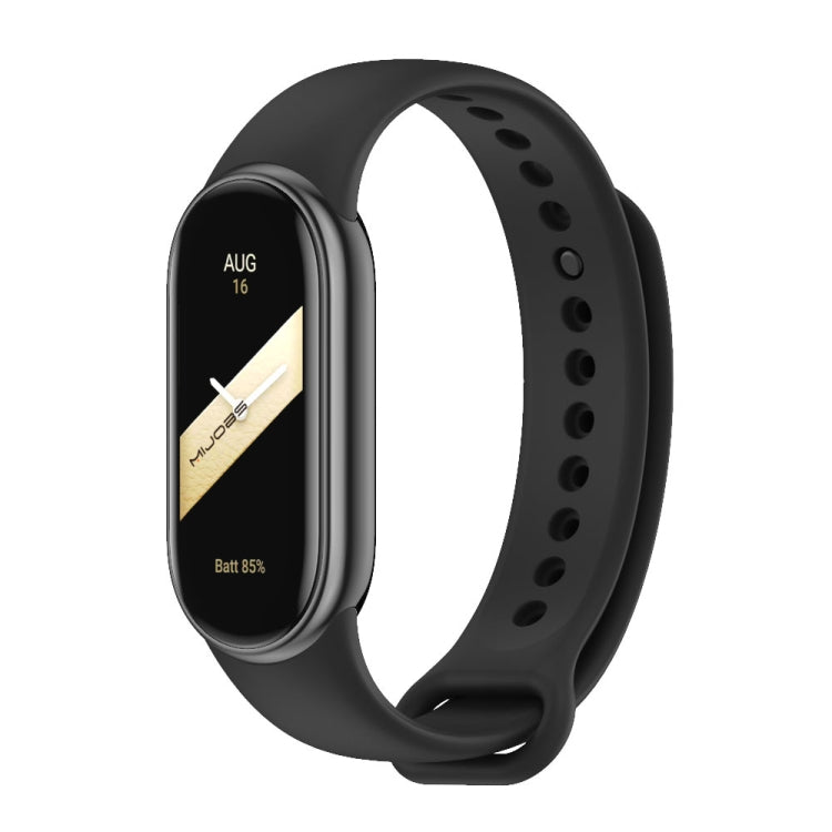 Black silicone watch band with adjustable holes and metal buckle, shown with a fitness tracker