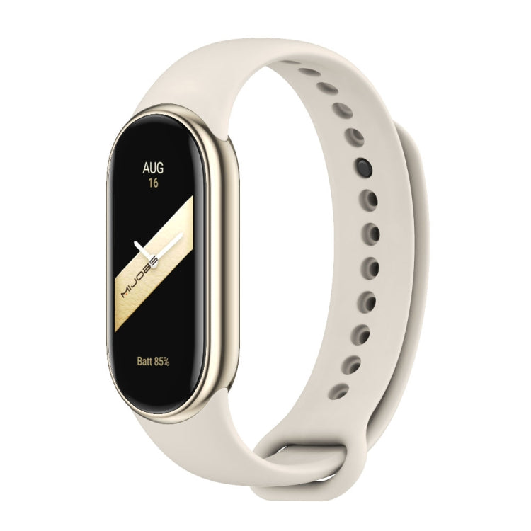 Off-white silicone watch band with adjustable holes and metal buckle, shown with a fitness tracker