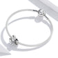 Silver bracelet with round clasp bead and witch hat charm with star cutouts