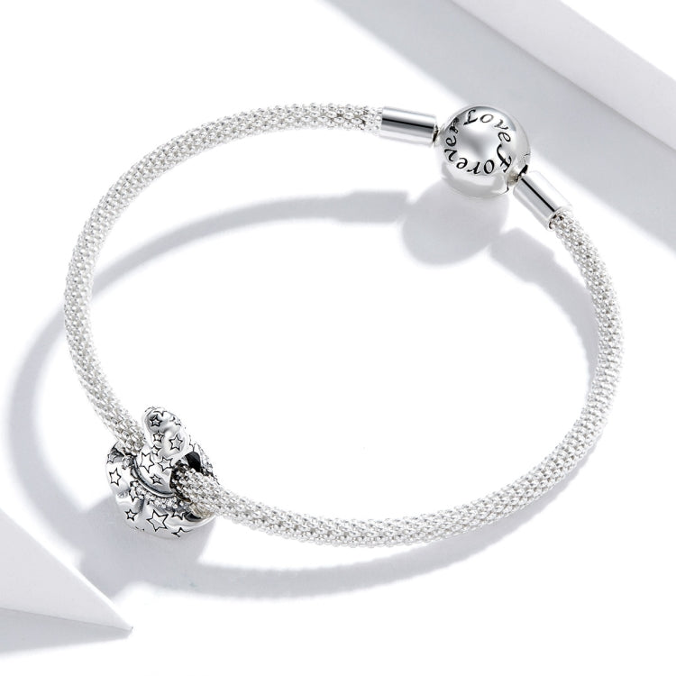 Silver bracelet with round clasp bead and witch hat charm with star cutouts