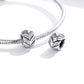 Snake-chain bracelet with two wheat heart charm beads, CZ stones, and black enamel