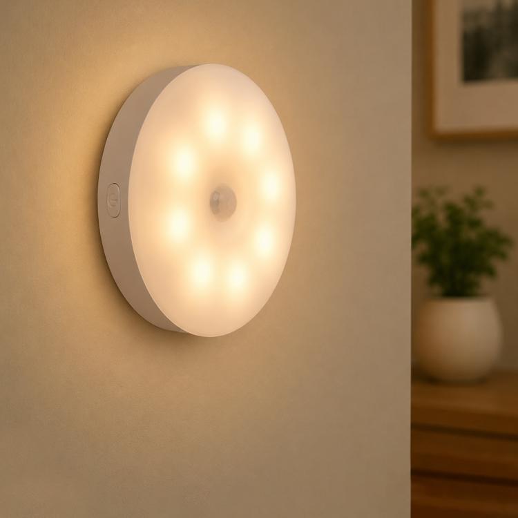 Wall-mounted round LED night light with warm glow and gray outer ring