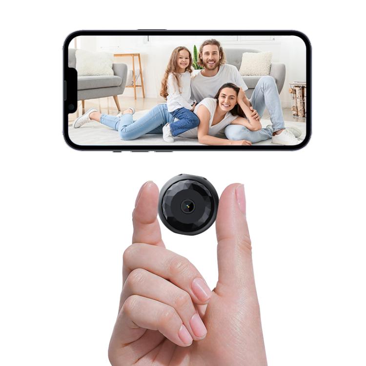 Mini security camera in a hand with smartphone screen showing live video
