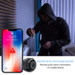 Mini security camera near a doorway with smartphone motion alert