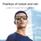 Black smart audio glasses with amber-tinted lenses worn by a man.