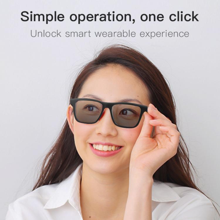 Black smart audio glasses with dark lenses worn by a woman.