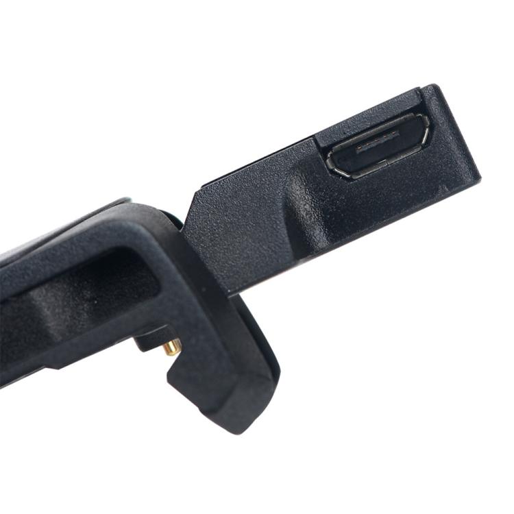 Close-up of the black charging base connector and a gold contact pin