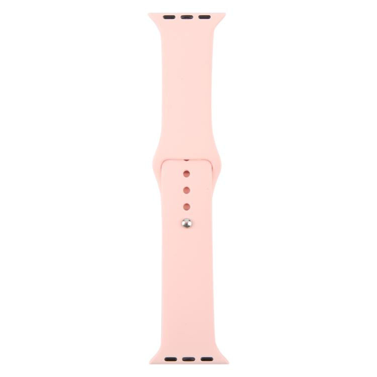 Light pink silicone watch band laid flat, showing adjustment holes and buckle pin