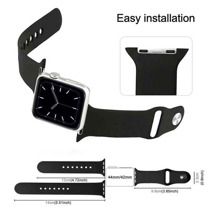 Black silicone watch band with metal stud closure and adjustable holes, shown on a watch
