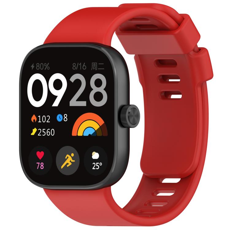 Red silicone sports watch band fitted to a black smartwatch, with buckle and adjustment holes.