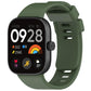 Dark green silicone sports watch band fitted to a black smartwatch, with buckle and adjustment holes.