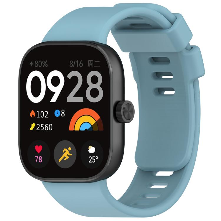 Light blue silicone sports watch band fitted to a black smartwatch, with buckle and adjustment holes.
