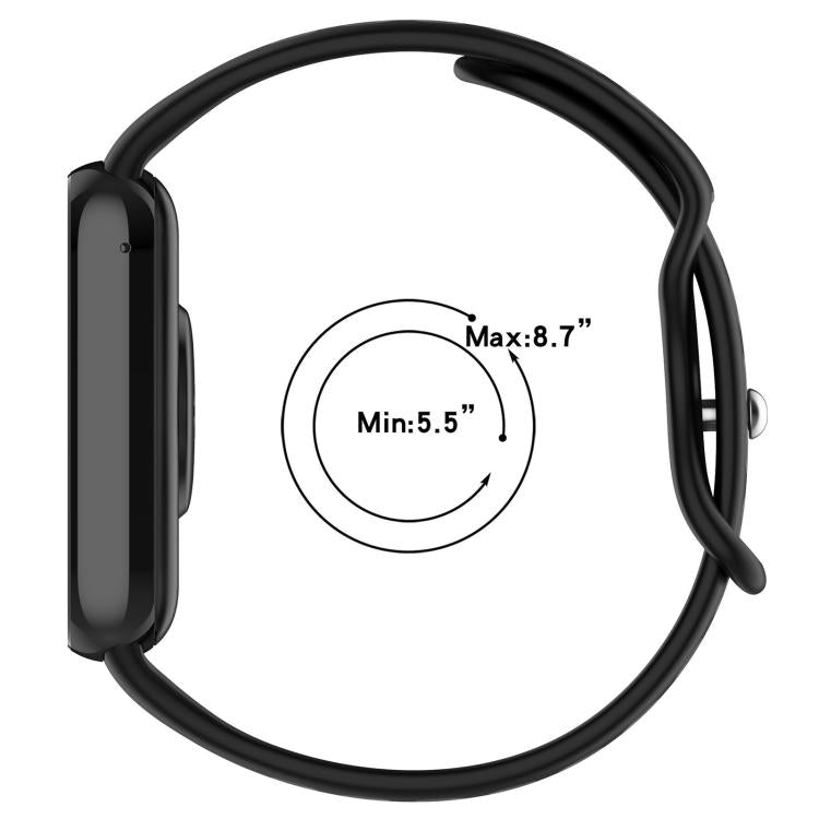 Black silicone watch band fitted to a watch, showing its adjustable wrist size range