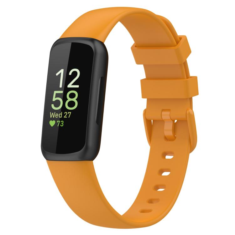 Fitbit Inspire 3 with an orange silicone watch band and black tracker