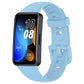 Light blue silicone watch band with buckle and adjustment holes, shown attached to a smartwatch.