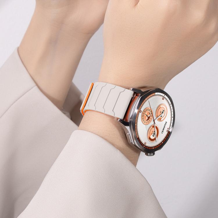 xDfind light gray silicone watch band with orange edging, worn on a wrist