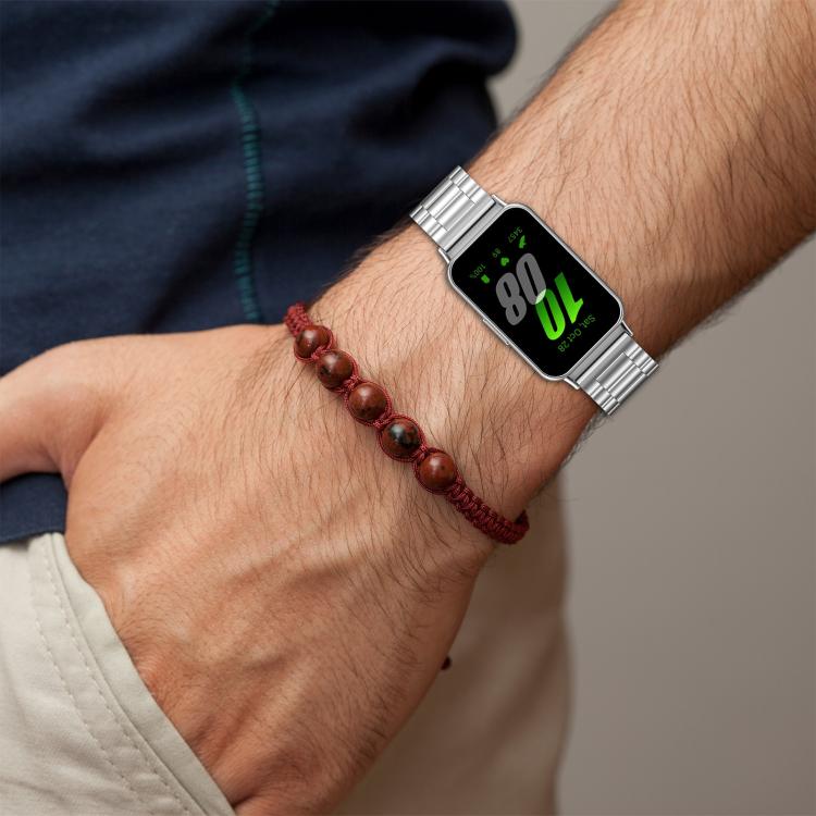Silver metal link watch band worn on a wrist.