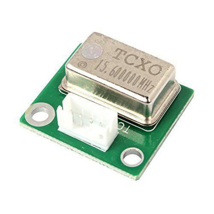 Crystal oscillator module with metal frequency can marked 15.600MHz on green board