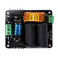 Black power module PCB with copper inductor coil, blue capacitors, and green connectors