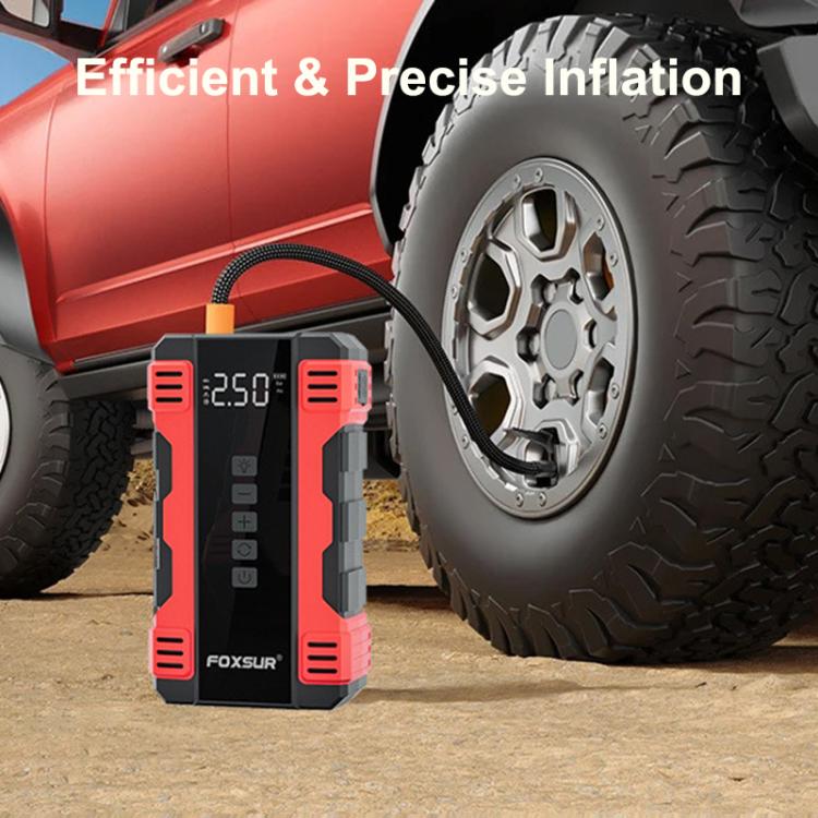 Red-and-black FOXSUR air compressor and jump starter next to a vehicle tire
