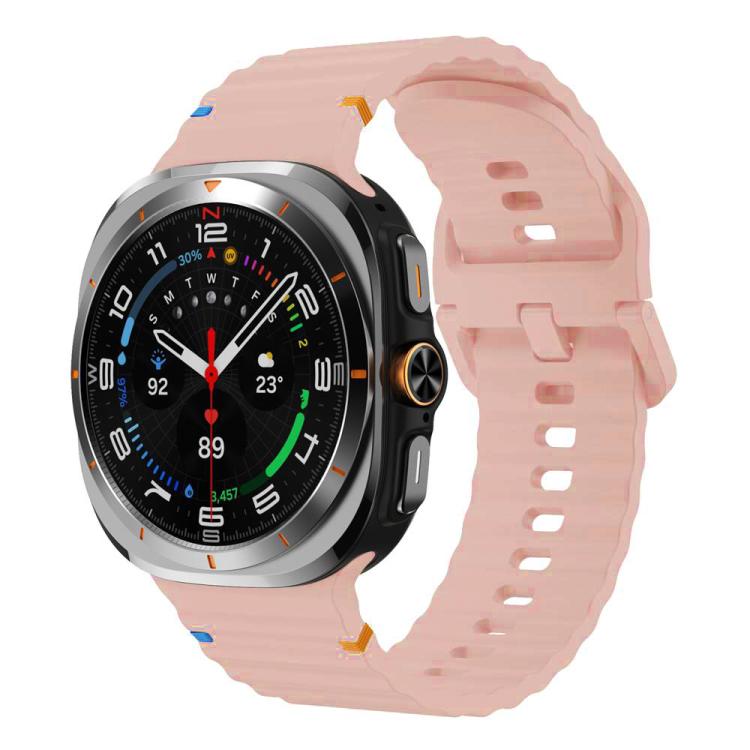 Pale pink silicone watch band with ridged texture and adjustable holes, shown on a Galaxy Watch