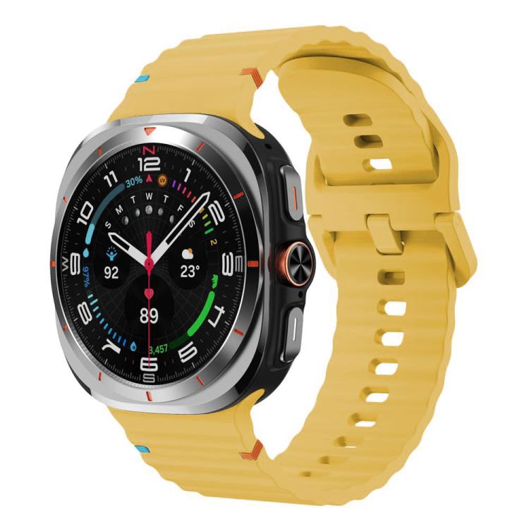 Yellow silicone watch band with ridged texture and adjustable holes, shown on a Galaxy Watch