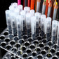 Transparent 96-hole acrylic brush/pencil stand filled with pencils and tubes