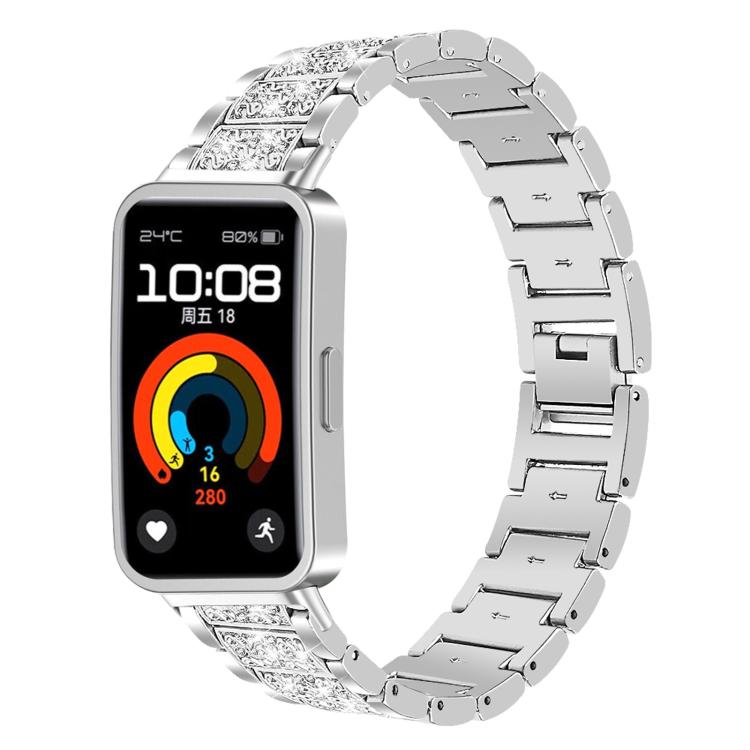 Silver stainless steel watch band with crystal-accented links, fitted to a rectangular fitness watch.