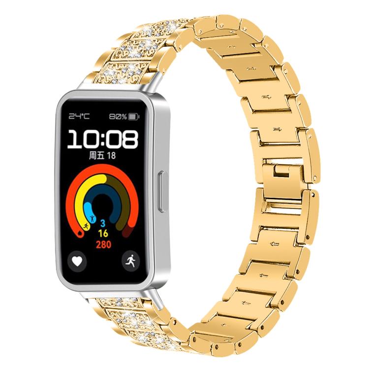 Gold stainless steel watch band with crystal-accented links, fitted to a rectangular fitness watch.