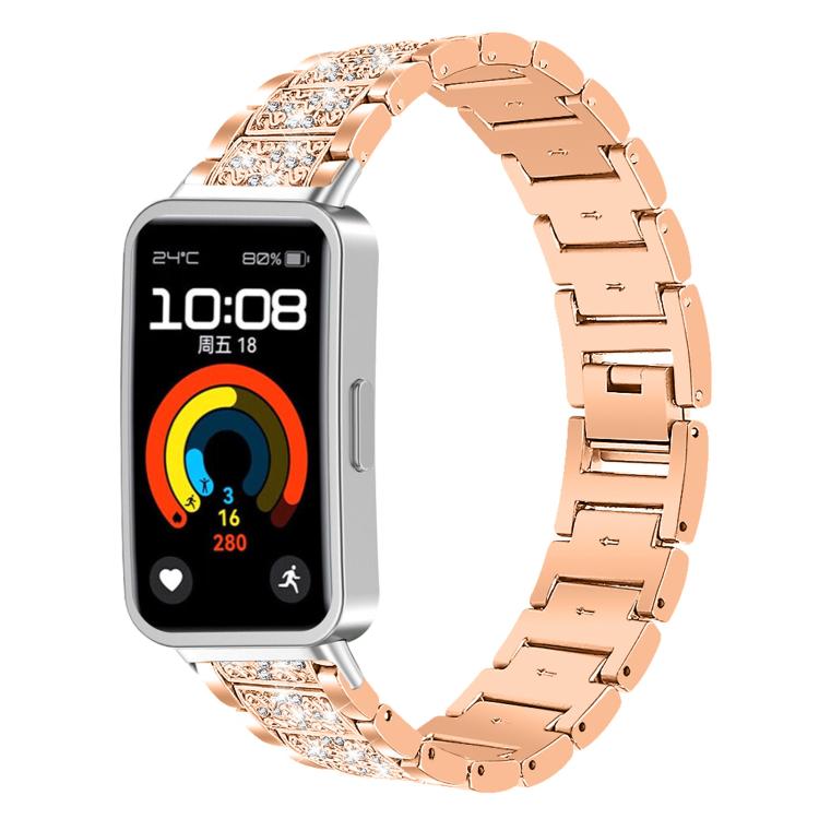 Rose gold stainless steel watch band with crystal-accented links, fitted to a rectangular fitness watch.
