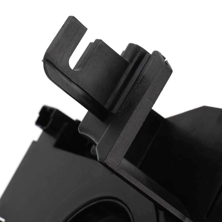Close-up of black clock spring with molded connector housing and mounting tabs