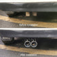 Stainless steel dual exhaust tailpipe with two round silver tips installed under car