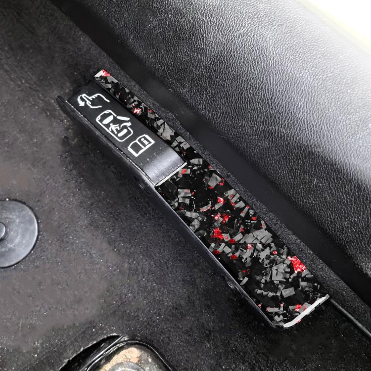 Door lock switch decorative sticker, black carbon-fiber style with red flecks, close-up