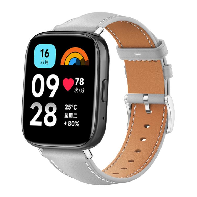 Grey leather watch band with tan lining, contrast stitching and silver buckle on a smartwatch with digital display