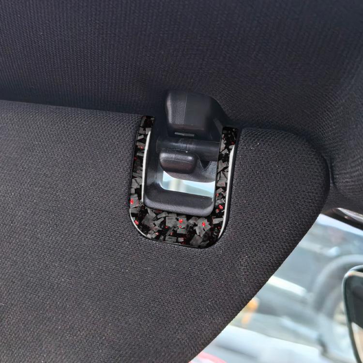 Car sun visor decorative sticker installed on handle trim, carbon-fiber style with red/black flecks
