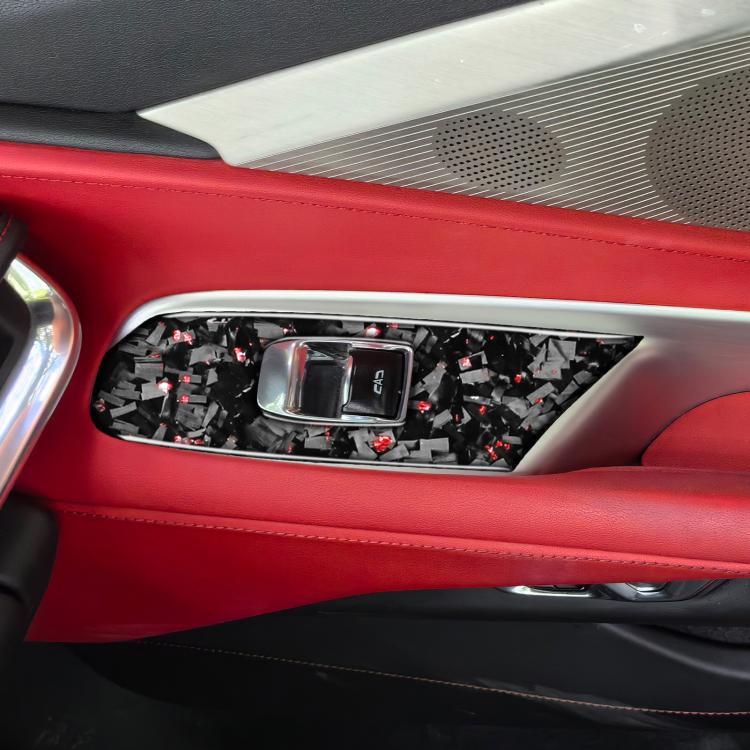 Window lift trim sticker set installed on car door panel, black carbon-fiber with red accents