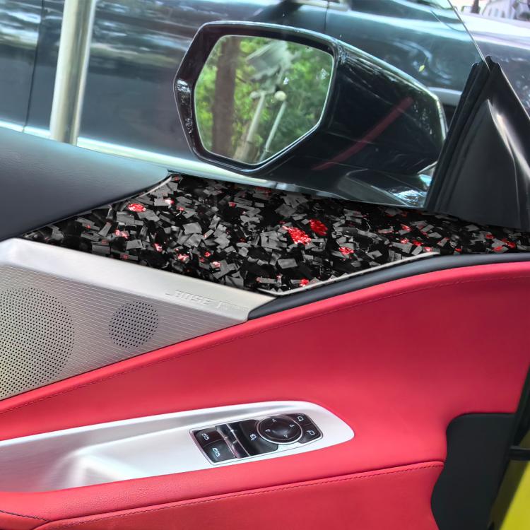 Black carbon-fiber decal strips with red fleck pattern on door speaker panel