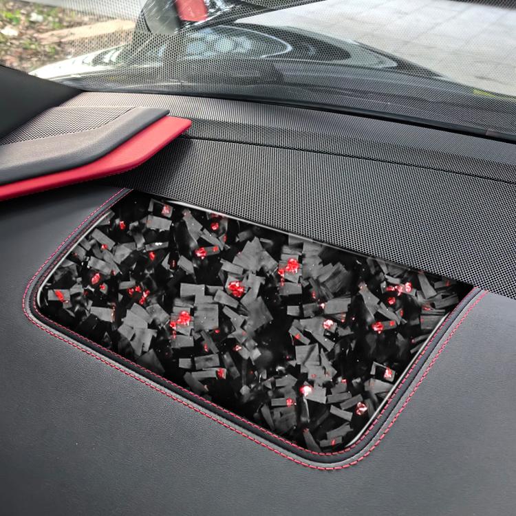 Carbon fiber-look seat panel sticker with red accent details, close-up on insert
