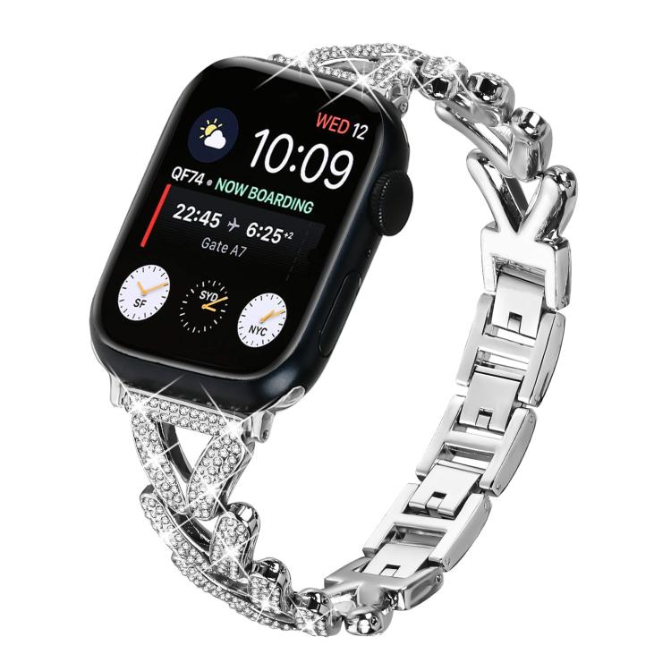 Silver xDfind Apple Watch band with crystal-studded clover links and polished metal clasp