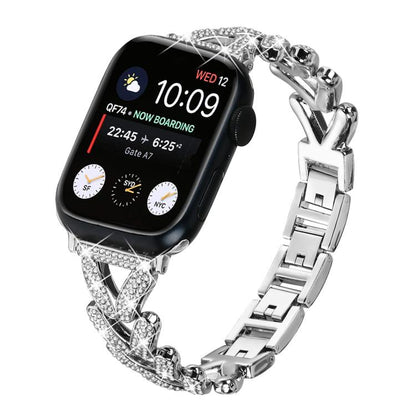 Silver xDfind Apple Watch band with crystal-studded clover links and polished metal clasp
