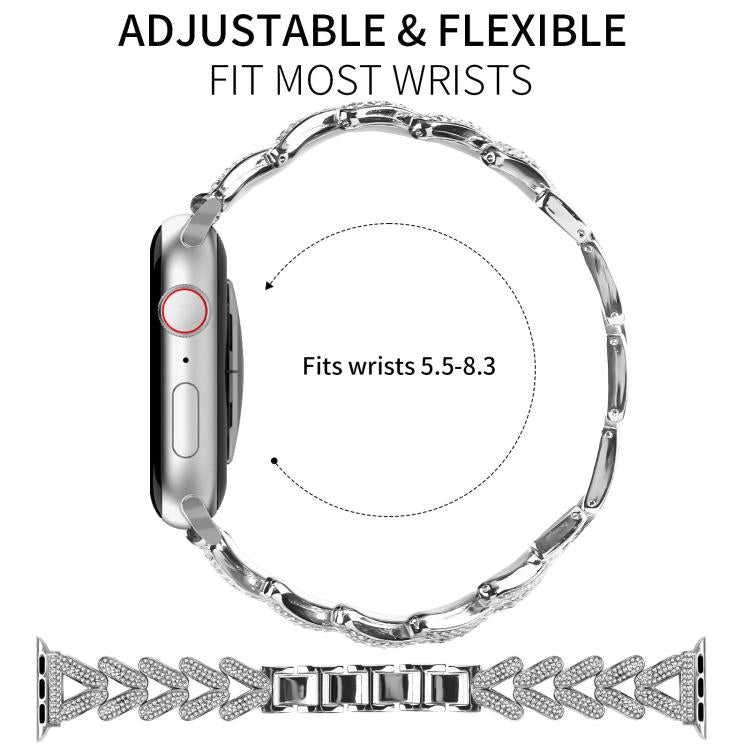 Silver metal Apple Watch band shown in a flexible loop, with crystal-studded clover links