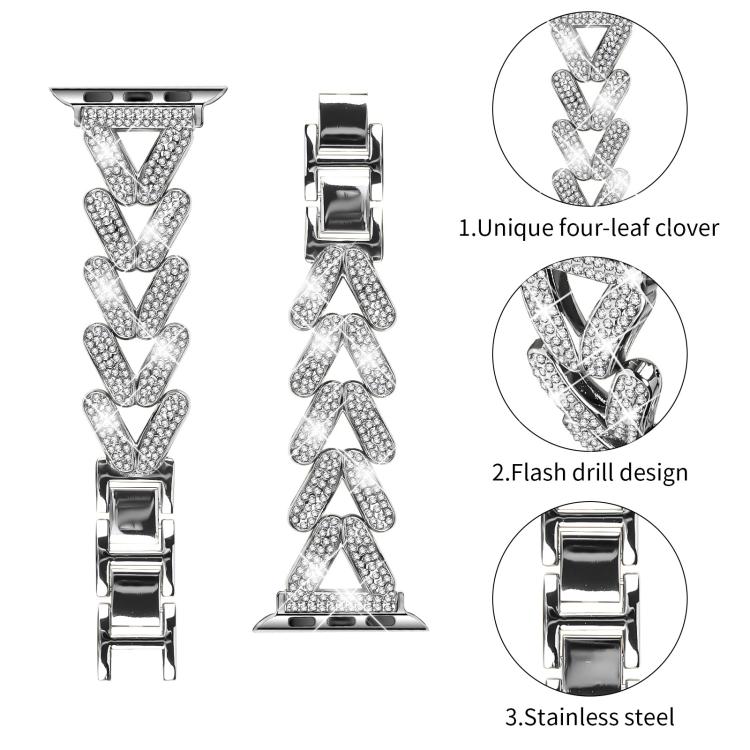Close-up of the silver band’s crystal-set clover links and stainless steel clasp