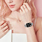 Apple Watch with a silver crystal-studded clover-link band worn on the wrist