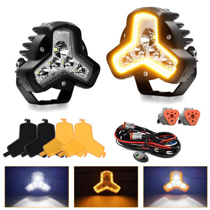 Pair of black triangular LED work lights with amber glow and mounting brackets
