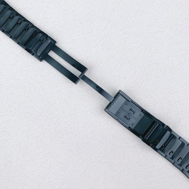 Black stainless steel watch band opened to show its folding clasp and inner links.