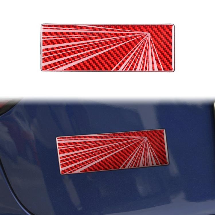 Rectangular red carbon-fiber style sticker with white radial burst pattern on car panel