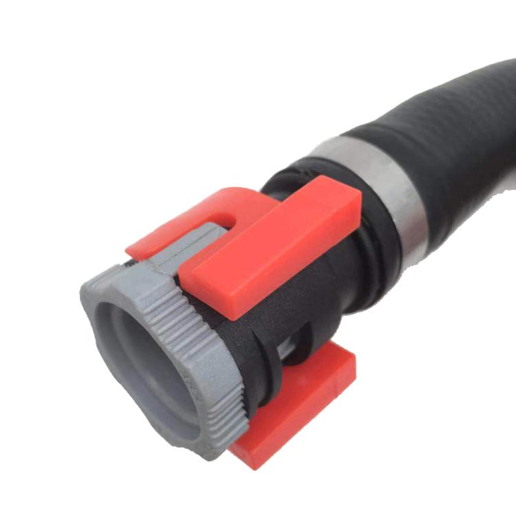 Heater hose disconnect tool with red latch on black hose