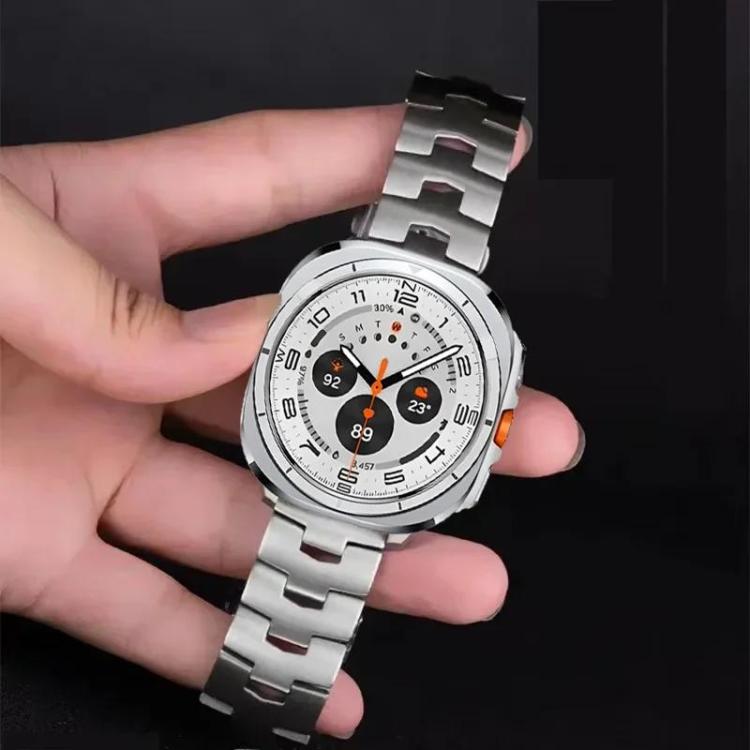 Silver titanium alloy watch band fitted to a smartwatch, held in hand
